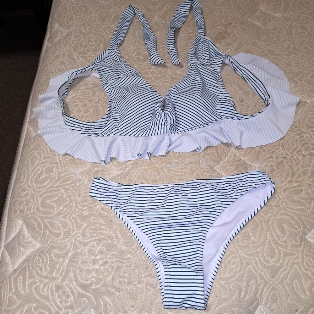 An unbranded 2 piece bikini  blue with white ruffles in a size medium.